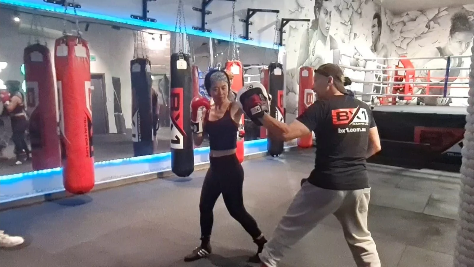 Woman training one-on-one boxing with a BX1 coach in Neutral Bay