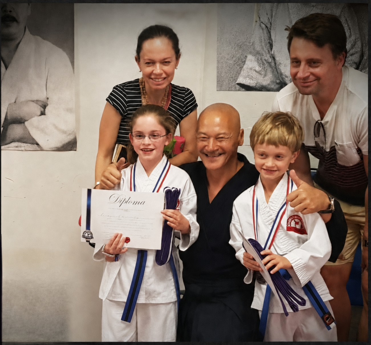 BX1 Kids Karate grading celebration with two students, their parents and coach