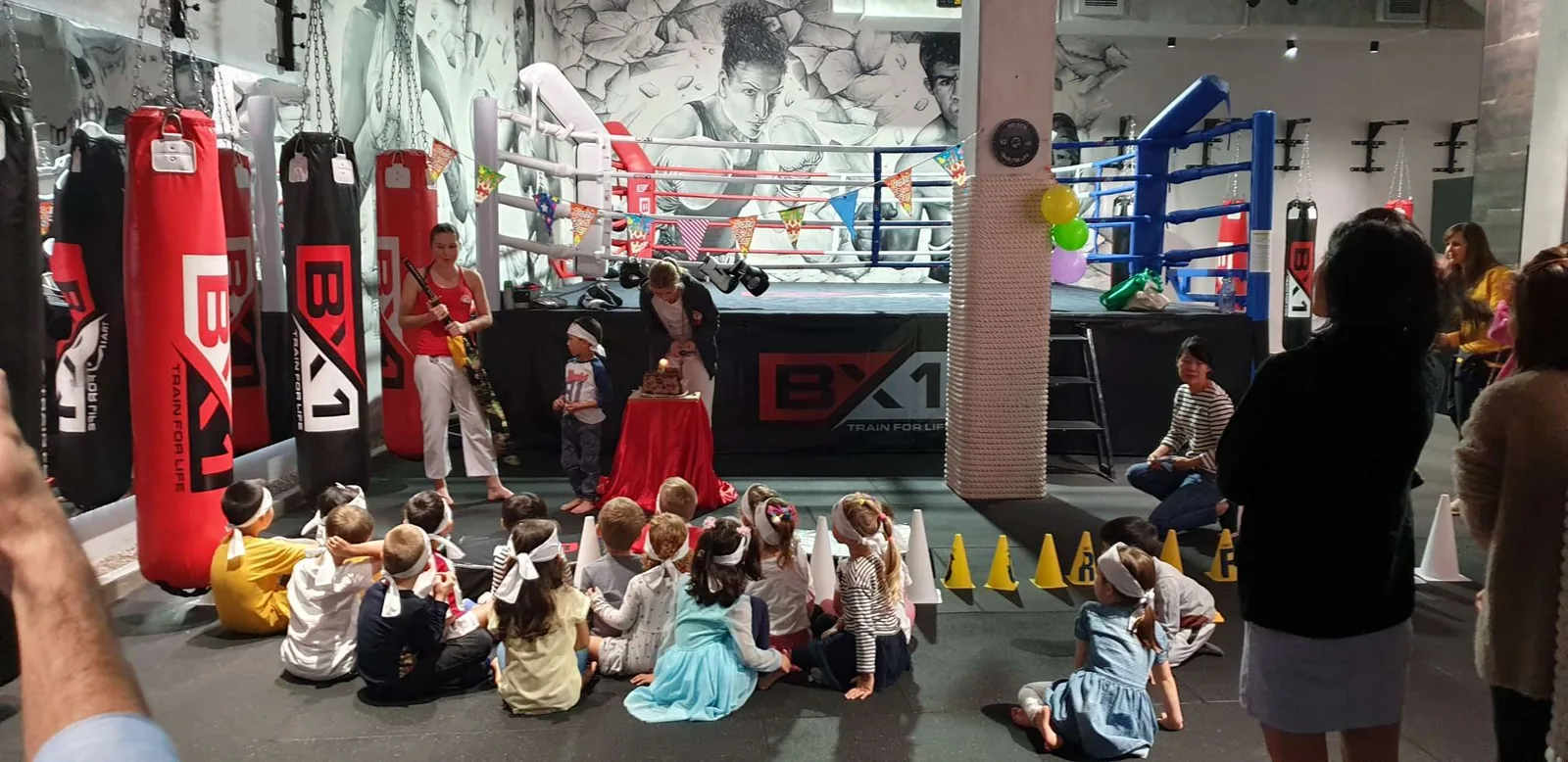Kids enjoying a martial arts birthday party beside the BX1 boxing ring in Neutral Bay
