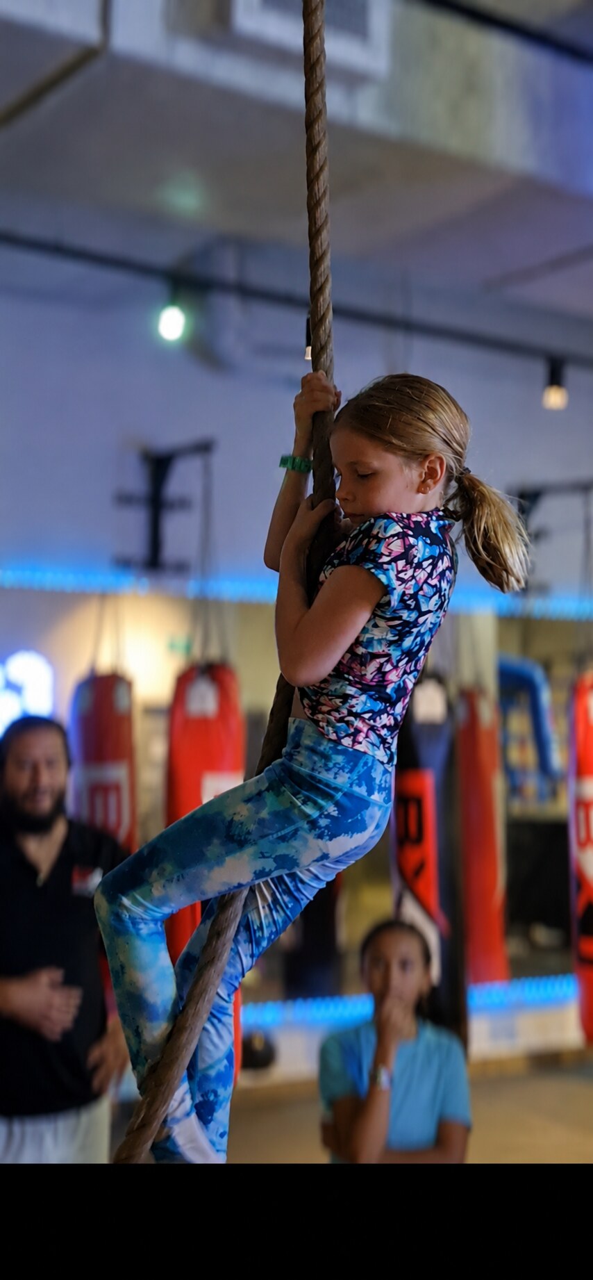 Girl using the indoor climbing rope during a supervised BX1 school holiday activity in Neutral Bay